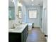 Bright bathroom featuring a double vanity, soaking tub, and glass-enclosed shower at 261 Arborview Dr, Mcdonough, GA 30252
