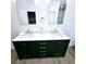 Bathroom boasting a double vanity with green cabinets and modern gold hardware at 261 Arborview Dr, Mcdonough, GA 30252