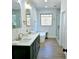A primary bathroom featuring double vanity, soaking tub, a window and large glass shower at 261 Arborview Dr, Mcdonough, GA 30252
