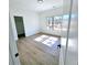 A bedroom with a large window providing lots of natural light and a glimpse of the outdoors at 261 Arborview Dr, Mcdonough, GA 30252