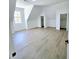 Bright bedroom with light wood floors, white walls, and natural light from the windows at 261 Arborview Dr, Mcdonough, GA 30252