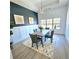 Dining room with wainscoting, a modern chandelier, and large windows at 261 Arborview Dr, Mcdonough, GA 30252