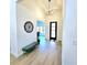 Inviting entryway features a modern light fixture, bench seat, and decorative wall art at 261 Arborview Dr, Mcdonough, GA 30252