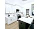 Bright, modern kitchen with white cabinets, a large island, and stainless steel appliances at 261 Arborview Dr, Mcdonough, GA 30252