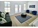Bright living room features double doors and natural light at 261 Arborview Dr, Mcdonough, GA 30252