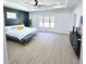Main bedroom with large windows, light hardwood flooring and modern fixtures at 261 Arborview Dr, Mcdonough, GA 30252