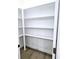 Bright pantry featuring new hardwood floors and white walls with built-in shelving at 261 Arborview Dr, Mcdonough, GA 30252
