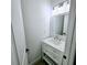 Powder room showcasing vanity with drawers, quartz countertop, and stylish mirror at 261 Arborview Dr, Mcdonough, GA 30252