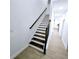 Bright staircase featuring hardwood steps and a sleek banister at 261 Arborview Dr, Mcdonough, GA 30252