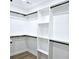 Walk-in closet features built-in shelving and closet rods at 261 Arborview Dr, Mcdonough, GA 30252