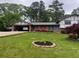 Charming single-Gathering home featuring a well-maintained front yard, covered carport, and brick facade at 3996 Indian Manor Dr, Stone Mountain, GA 30083