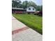 Well-manicured lawn and sidewalk leading up to a traditional home with mature landscaping and brick accents at 3996 Indian Manor Dr, Stone Mountain, GA 30083