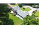 Aerial view of a well-manicured backyard, two-story home, and mature landscaping at 3996 Indian Manor Dr, Stone Mountain, GA 30083