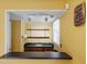 Bar area with serving window, sink, open shelves, wood cabinets, and track lighting at 3996 Indian Manor Dr, Stone Mountain, GA 30083