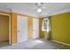 Bright bedroom featuring a ceiling fan, a window with natural light, and two closets at 3996 Indian Manor Dr, Stone Mountain, GA 30083