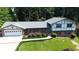Charming two-story home with brick facade, attached two-car garage, and well-manicured lawn at 3996 Indian Manor Dr, Stone Mountain, GA 30083