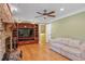 Cozy living room with hardwood floors, stone fireplace, and built-in shelving at 3996 Indian Manor Dr, Stone Mountain, GA 30083