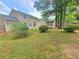 A large backyard features green grass and mature trees, perfect for outdoor enjoyment at 5229 Mountain Village Ct, Stone Mountain, GA 30083