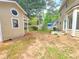Large backyard featuring some grass, a storage building, and mature trees at 5229 Mountain Village Ct, Stone Mountain, GA 30083