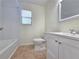 A modern bathroom featuring a tiled floor, white vanity and a shower-tub combo at 5229 Mountain Village Ct, Stone Mountain, GA 30083