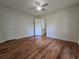 This spacious bedroom has wood-look floors, white walls, and a ceiling fan at 5229 Mountain Village Ct, Stone Mountain, GA 30083