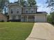 Charming two-story home with a covered front porch and attached garage, perfect for suburban living at 5229 Mountain Village Ct, Stone Mountain, GA 30083