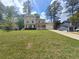 Beautiful two-story home with an attached garage, complemented by a lush green lawn and a sunny sky at 5229 Mountain Village Ct, Stone Mountain, GA 30083