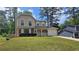 Inviting two-story home featuring an attached garage, well-maintained lawn, and classic architectural details at 5229 Mountain Village Ct, Stone Mountain, GA 30083