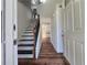 Inviting foyer with staircase and dark hardwood floors at 5229 Mountain Village Ct, Stone Mountain, GA 30083