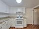 Traditional kitchen features white cabinets and granite countertops at 5229 Mountain Village Ct, Stone Mountain, GA 30083