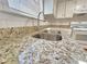 Granite countertop, subway tile backsplash, and stainless-steel sink at 5229 Mountain Village Ct, Stone Mountain, GA 30083