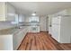 Bright kitchen with white appliances, granite countertops and tile backsplash at 5229 Mountain Village Ct, Stone Mountain, GA 30083