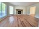 Sunlit living room features hardwood floors and a stone fireplace at 5229 Mountain Village Ct, Stone Mountain, GA 30083