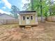 Charming storage building features a door, two windows and a small porch at 5229 Mountain Village Ct, Stone Mountain, GA 30083