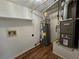 This utility room features wood-look floors, shelving, water heater and HVAC unit at 5229 Mountain Village Ct, Stone Mountain, GA 30083