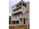 Features multiple levels of balconies and a garage below at 9244 Main Street # 102, Woodstock, GA 30188