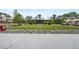 Scenic community green space with lawn, stage, and inviting seating areas surrounded by elegant neighborhood homes at 9244 Main Street # 102, Woodstock, GA 30188