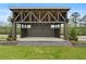 Well-built outdoor stage with a truss roof, perfect for community events, set on a well-manicured lawn at 9244 Main Street # 102, Woodstock, GA 30188