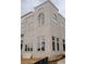 Corner view of a modern brick townhouse with large windows and stylish architectural details at 9244 Main Street # 102, Woodstock, GA 30188
