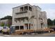 Multi-story building with balconies above a three-car garage in a mixed facade at 9244 Main Street # 102, Woodstock, GA 30188