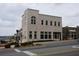 Exterior view of new building with storefront windows and classic brickwork at 9244 Main Street # 102, Woodstock, GA 30188