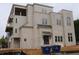 Multi-story townhouse featuring mixed materials, balconies, brick details, and an inviting entrance at 9244 Main Street # 102, Woodstock, GA 30188