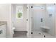 Modern bathroom features a glass enclosed shower with a built-in bench and marble tile at 110 Doris Path, Dallas, GA 30157