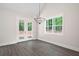 Bright dining room features a modern chandelier, large windows, and french doors at 110 Doris Path, Dallas, GA 30157