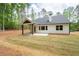 Backyard view of home featuring a covered patio and green landscaping at 110 Doris Path, Dallas, GA 30157