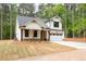 Charming two-story home with white siding, stone accents, and an attached garage at 110 Doris Path, Dallas, GA 30157