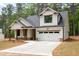 Charming exterior elevation featuring white siding, stone accents, and a welcoming front porch at 110 Doris Path, Dallas, GA 30157