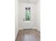 A modern hallway featuring gray wood-look flooring and a white door with glass insert at 110 Doris Path, Dallas, GA 30157