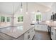 Bright and airy kitchen featuring a center island, stainless steel appliances, and sleek fixtures at 110 Doris Path, Dallas, GA 30157