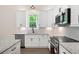 Modern kitchen features stainless steel appliances, granite countertops, and white cabinetry at 110 Doris Path, Dallas, GA 30157